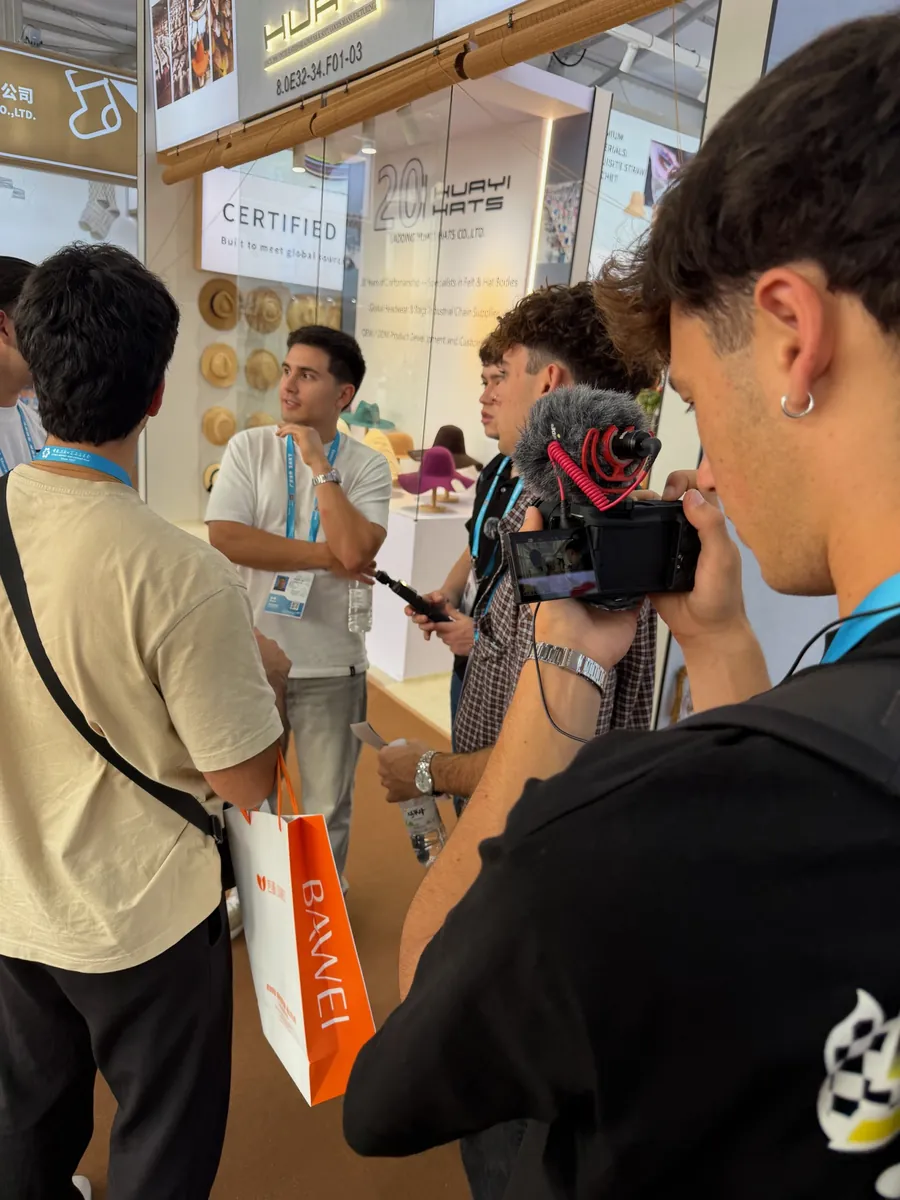 The team filming at an exhibition stand