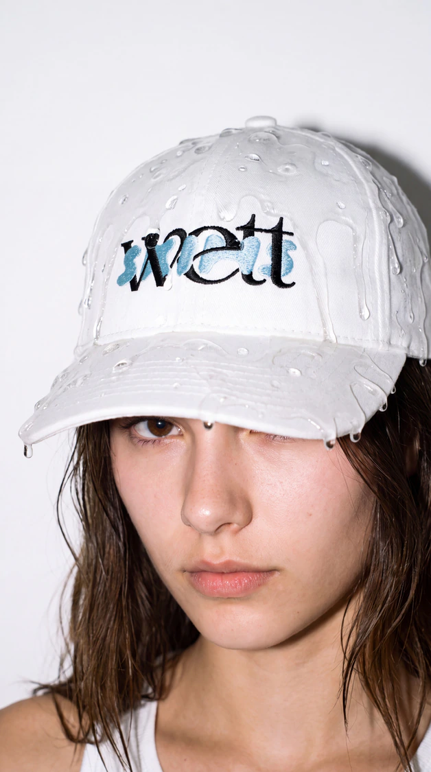 A model in a white Wett cap.