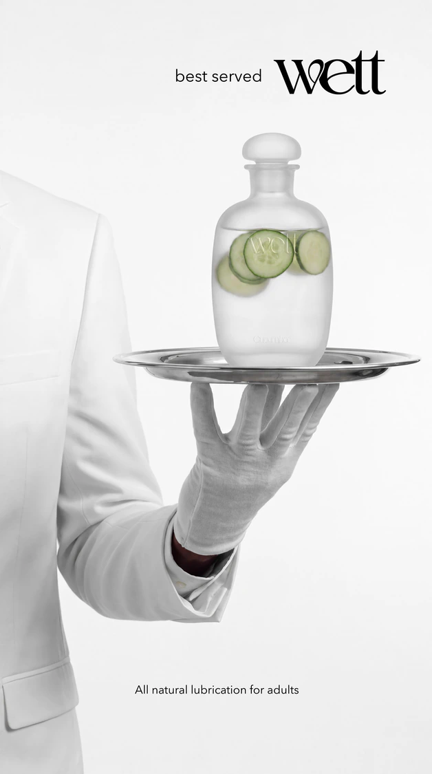 Ad: a waiter’s gloved hand holding the Wett bottle on a tray, ‘best served Wett’.