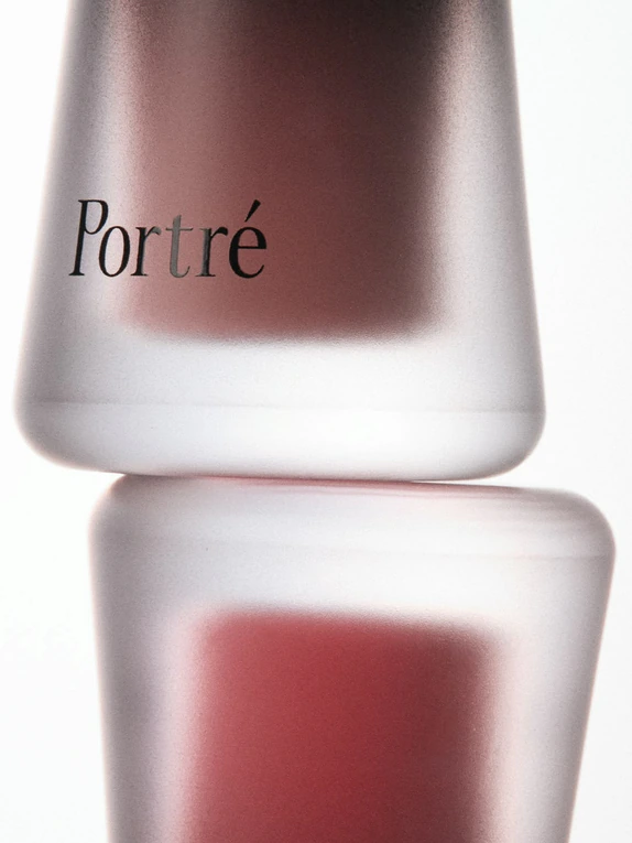 Two frosted red glass vessels stacked on each other.