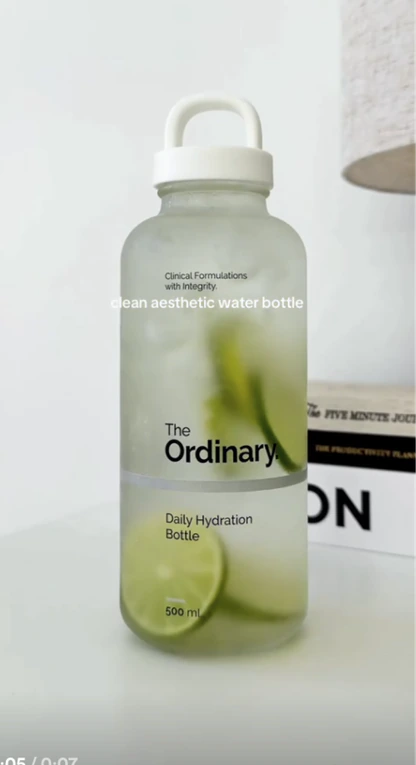 A frosted water bottle filled with lime slices.
