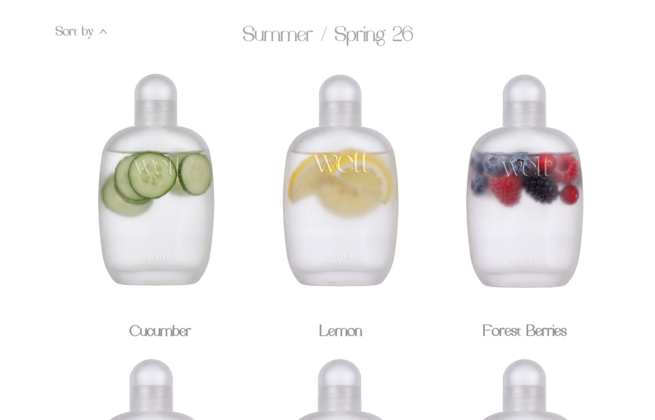 The Wett store design on a laptop: the Summer / Spring 26 range of cucumber, lemon and forest berries bottles.